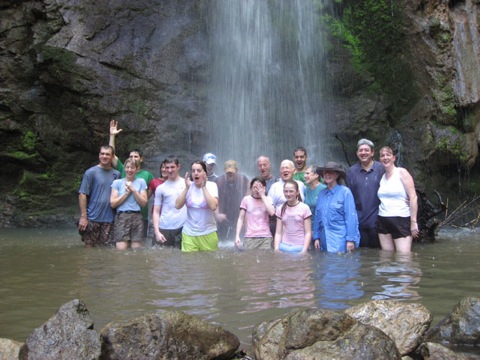 family_under_waterfall